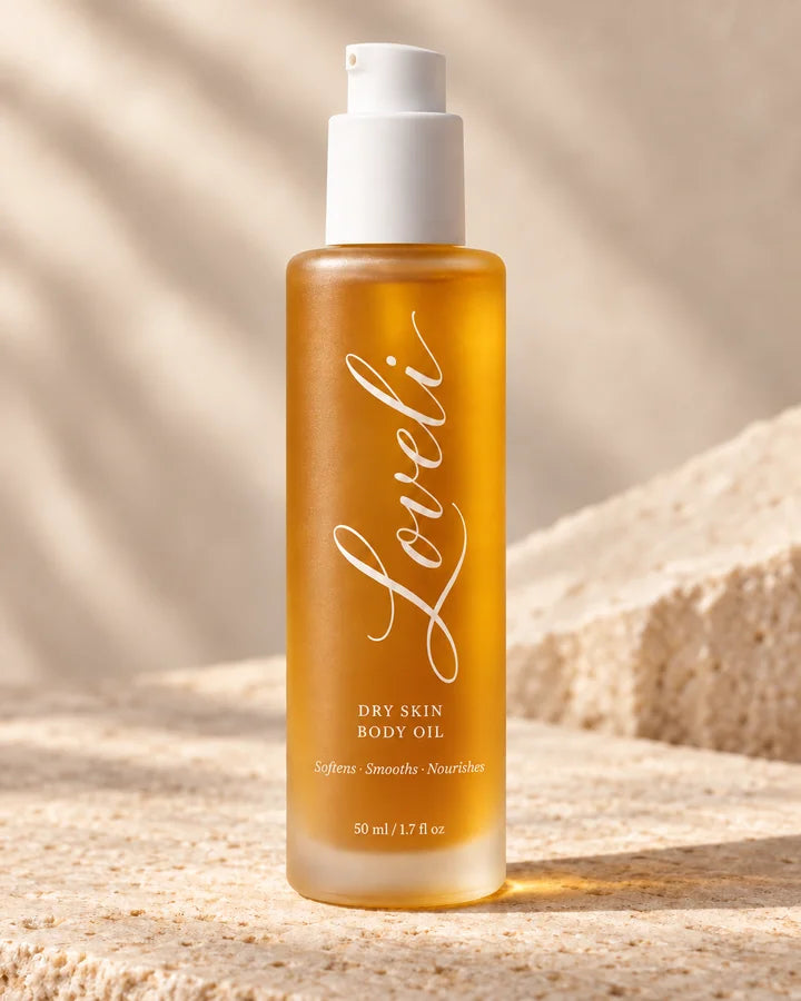 Loveli body oil on warm stone in sunlight