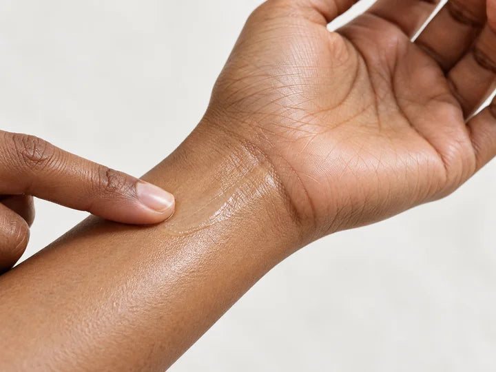A thin layer of body oil spread across skin